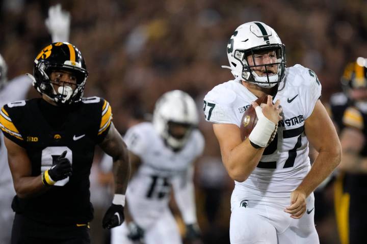 Michigan State linebacker Cal Haladay (27) runs from Iowa wide receiver Diante Vines (0) while ...