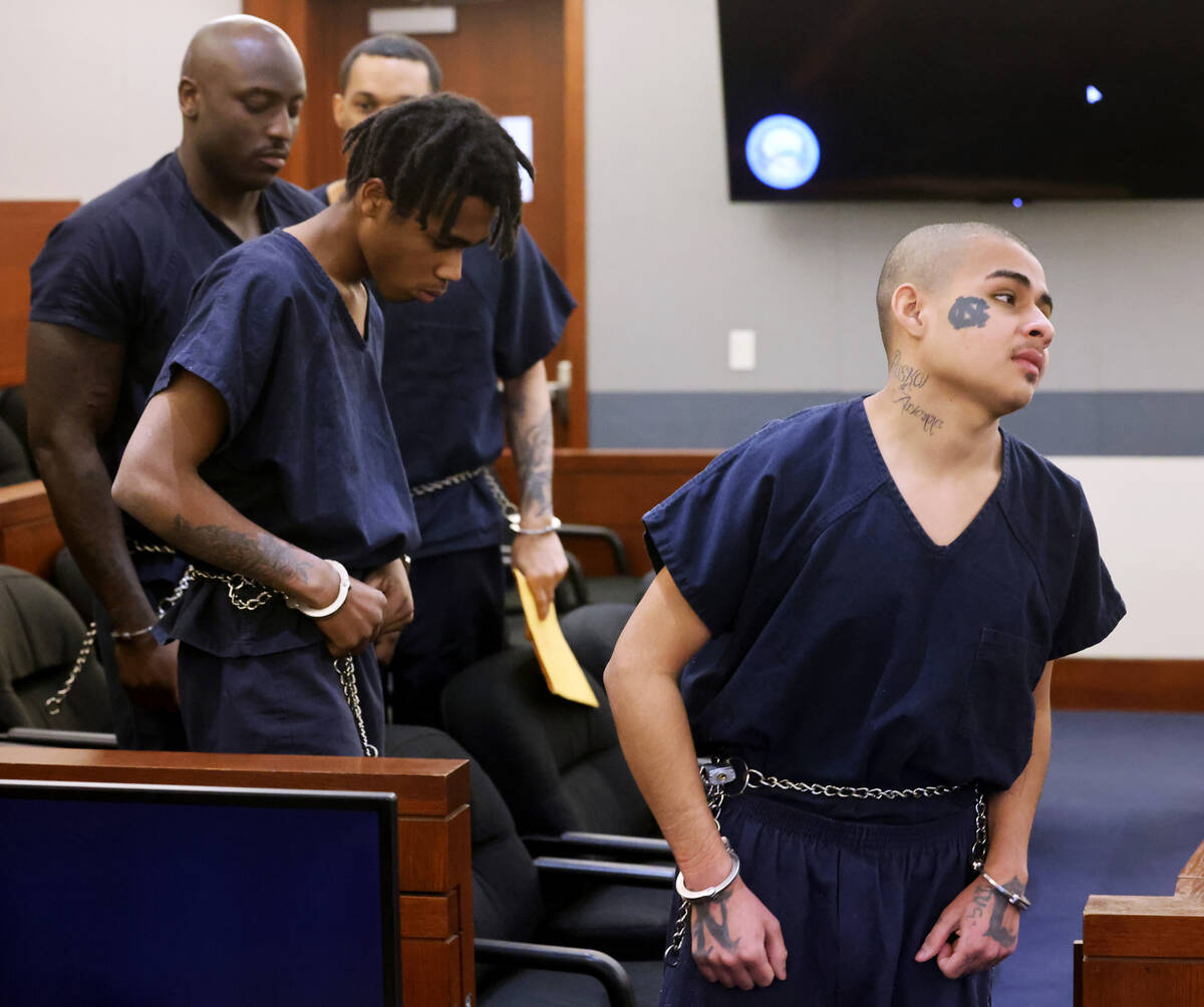 Jesus Ayala, 18, right, and Jzamir Keys, 16, walk out of court at the Regional Justice Center i ...