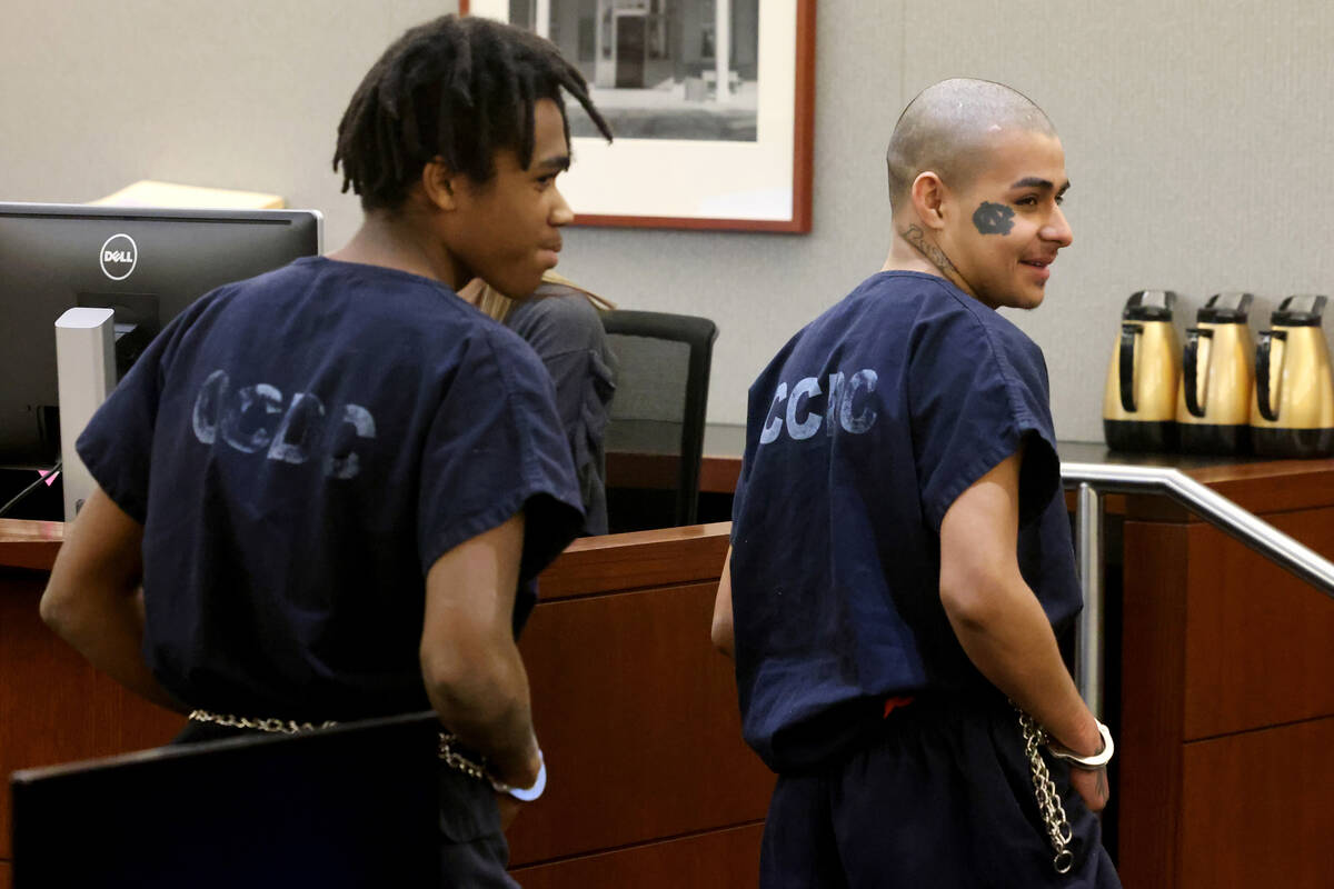 Jesus Ayala, 18, right, and Jzamir Keys, 16, smile at the wife and daughter of the victim as th ...