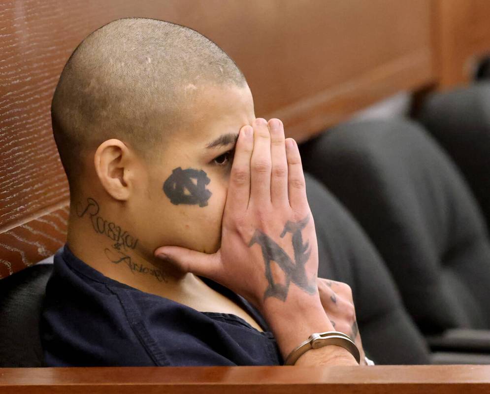Jesus Ayala, 18, appears to raise his middle finger at the wife and daughter of the victim at t ...