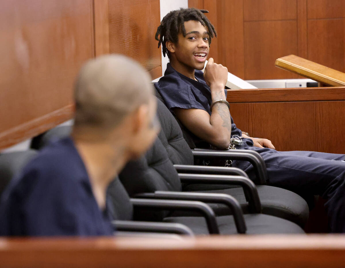 Jesus Ayala, 18, left, and Jzamir Keys, 16, laugh as they wait to appear in court at the Region ...