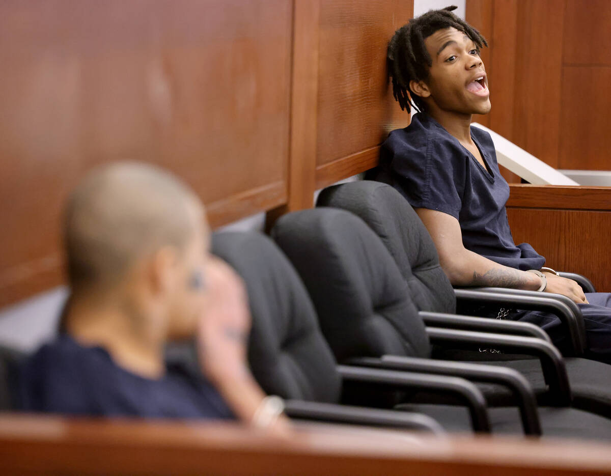 Jesus Ayala, 18, left, and Jzamir Keys, 16, laugh as they wait to appear in court at the Region ...