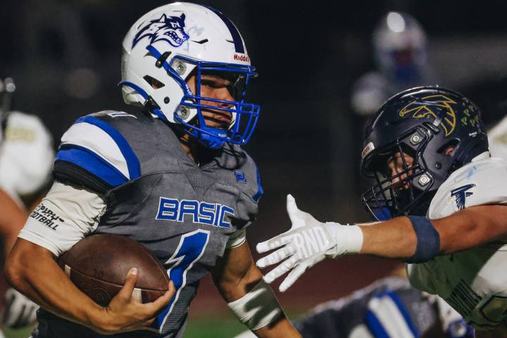 Basic quarterback Anthony Vega (1) runs the ball past a Foothill defender during a game at Basi ...
