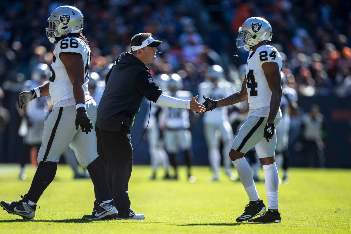 Raiders head coach Josh McDaniels congratulates Raiders cornerback Marcus Peters (24) after the ...