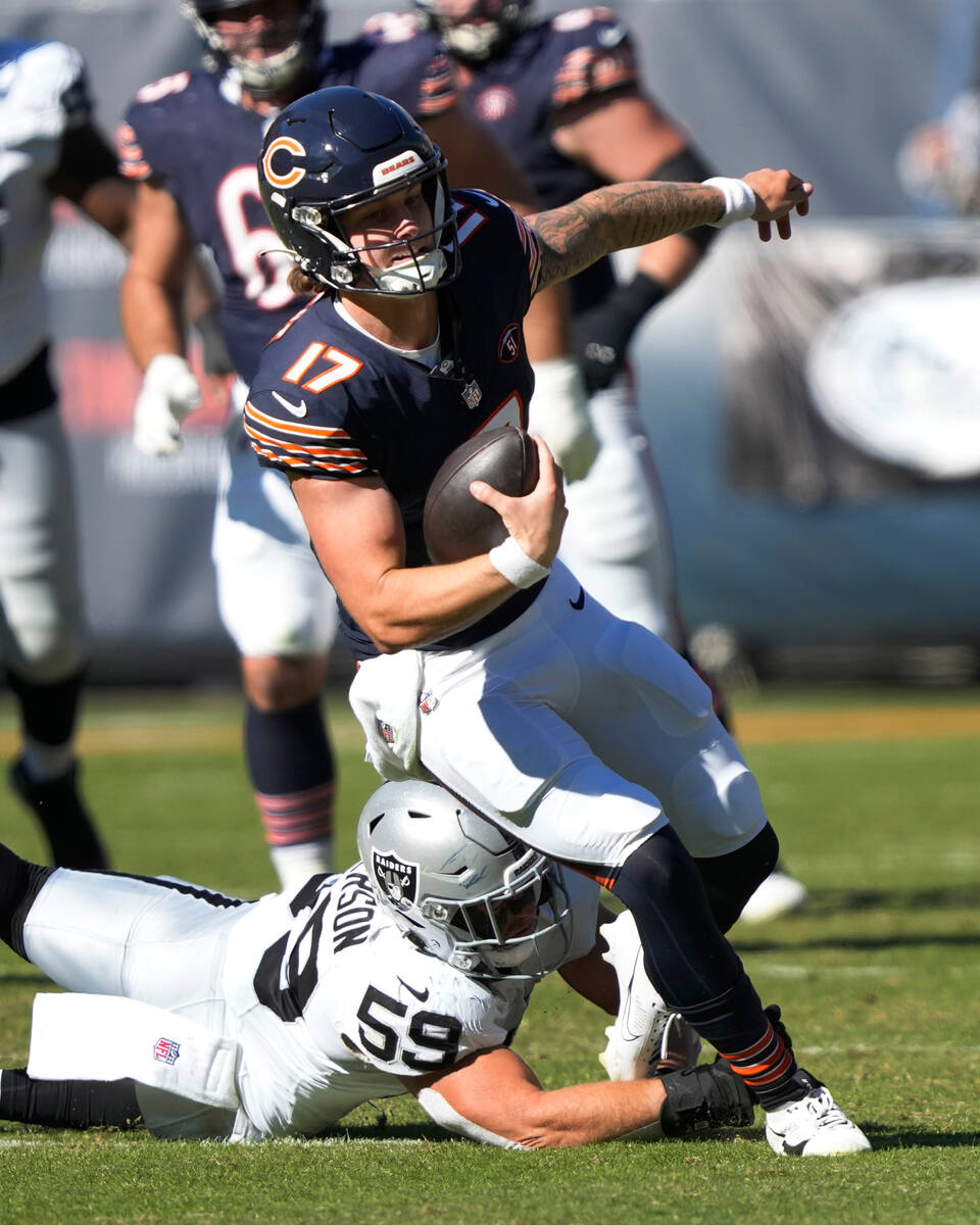 Chicago Bears quarterback Tyson Bagent carries the ball during an NFL football game against the ...