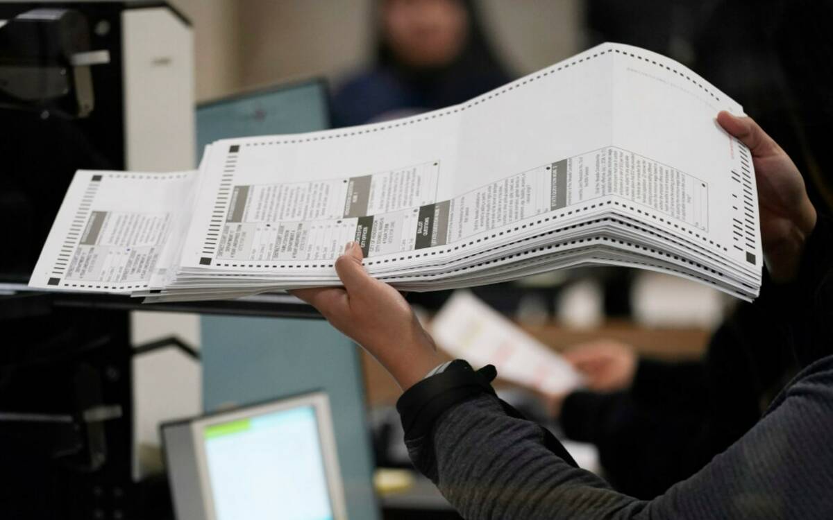 An election worker processes ballots at the Clark County Election Department, Friday, Nov. 11, ...