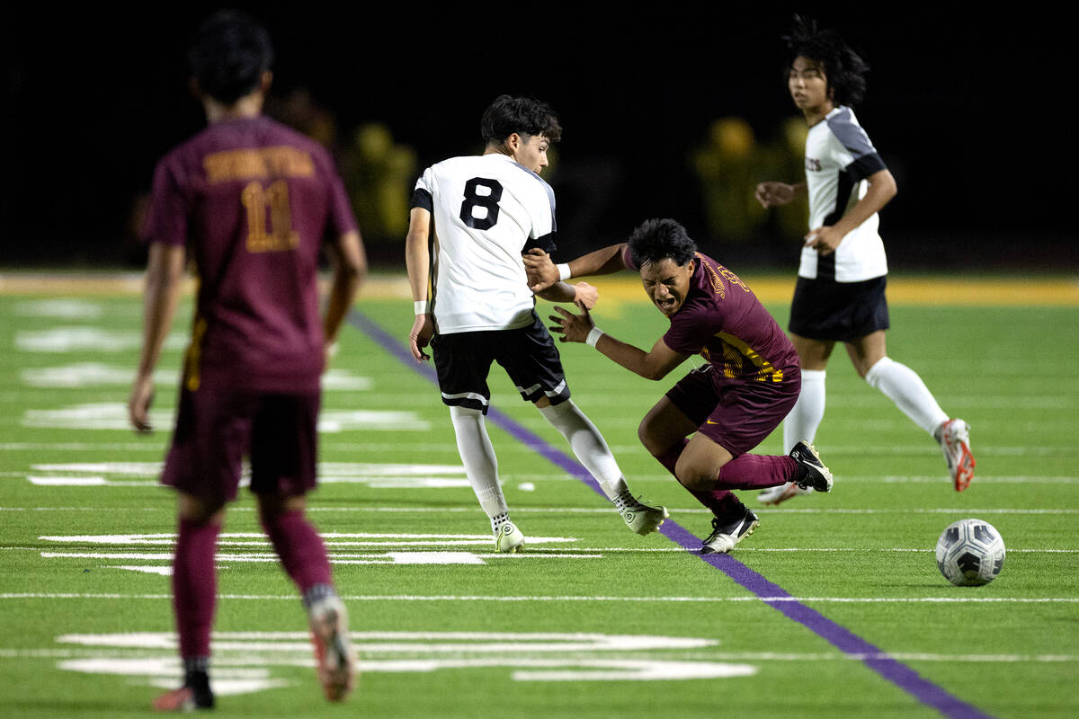 Eldorado midfielder Rogelio Berto (8) is tripped up by Las Vegas' Oscar Sandoval (8) during the ...