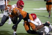 Arbor View’s Braylen Gardner (24) and Nathanial Hoskins (16) tackle Legacy wide receiver ...