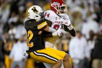 Wyoming safety Isaac White, left, tries to tackle Fresno State tight end Tre Watson during the ...