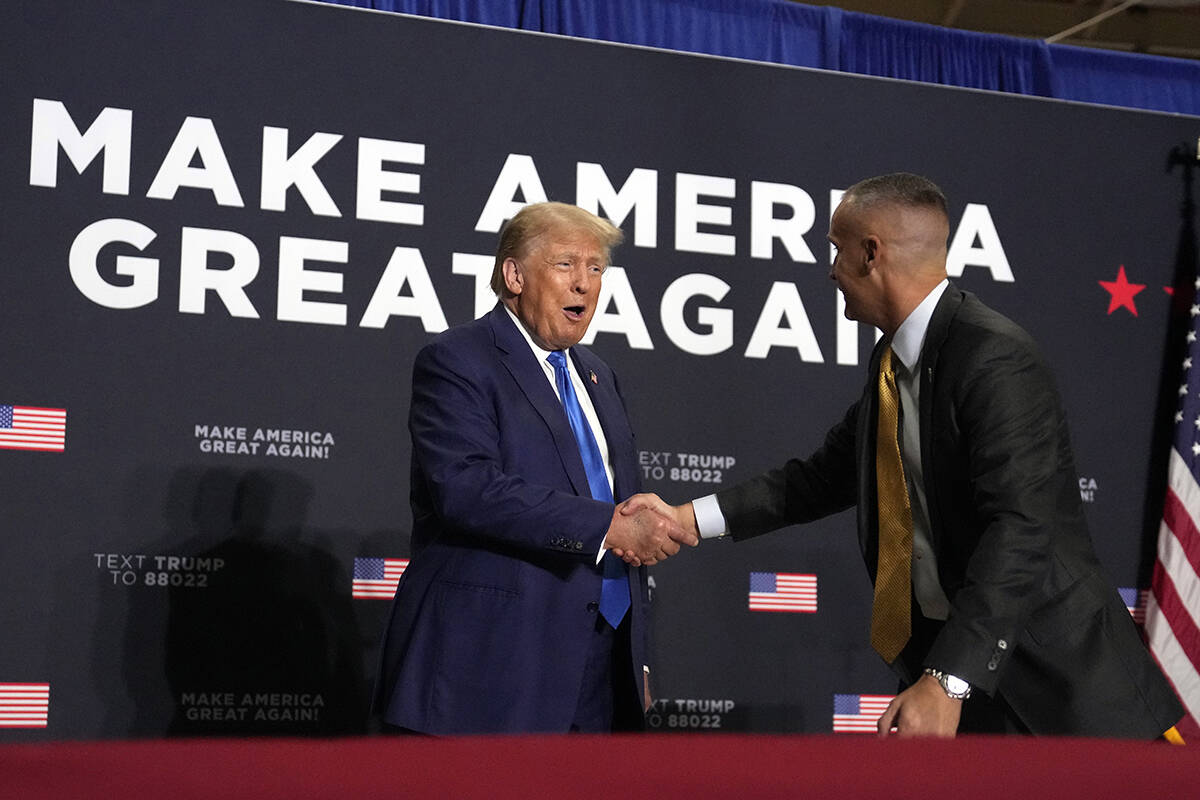 Republican presidential candidate former President Donald Trump shakes hands with Corey Lewando ...