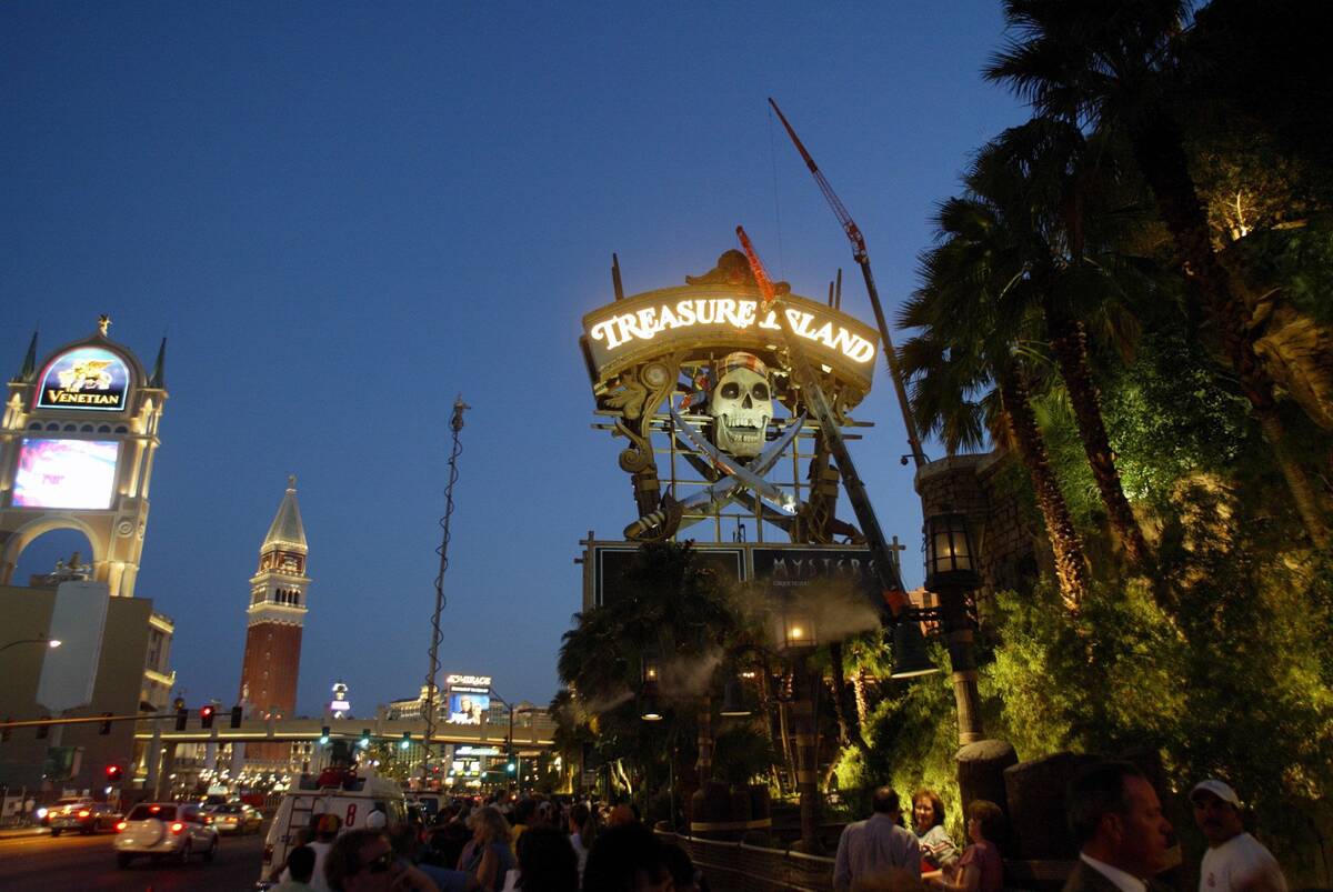 Spectators and the news media prepare to watch the skull in the Treasure Island marquee to come ...
