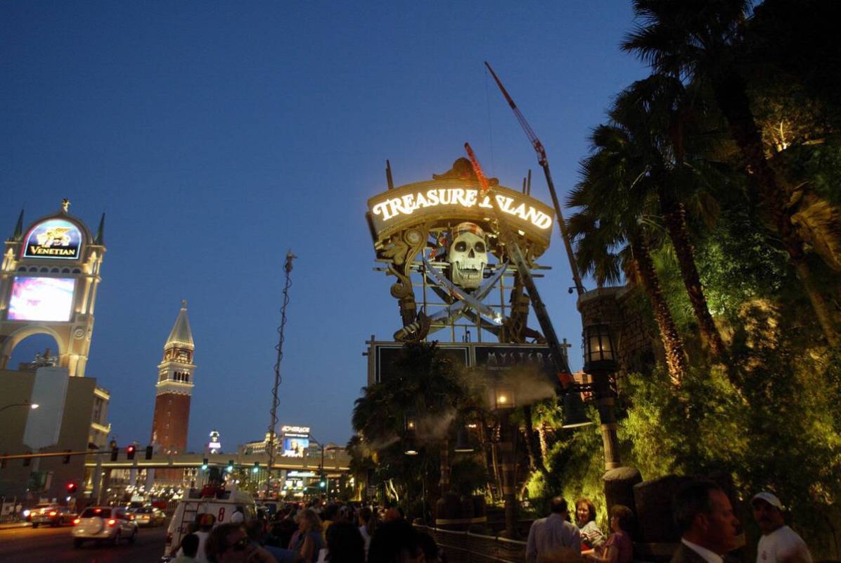 Spectators and the news media prepare to watch the skull in the Treasure Island marquee to come ...