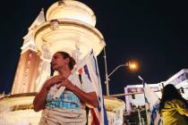 A person holds up an Israeli flag during a pro-Israel rally at The Venetian on Sunday, Oct. 8, ...