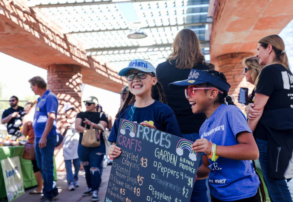 Ariani Peña, 9, left, and Jessie Cruz, 8, right, from Marion Earl Elementary School, hold a si ...