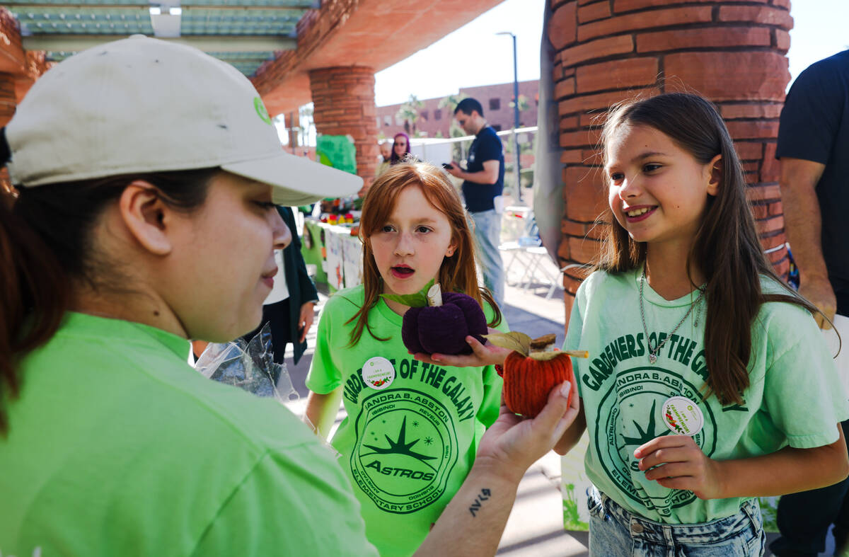 Charlotte Rowe, 9, center, and Victoria Zemskov, 10, right, show Abston Elementary’s goods fo ...