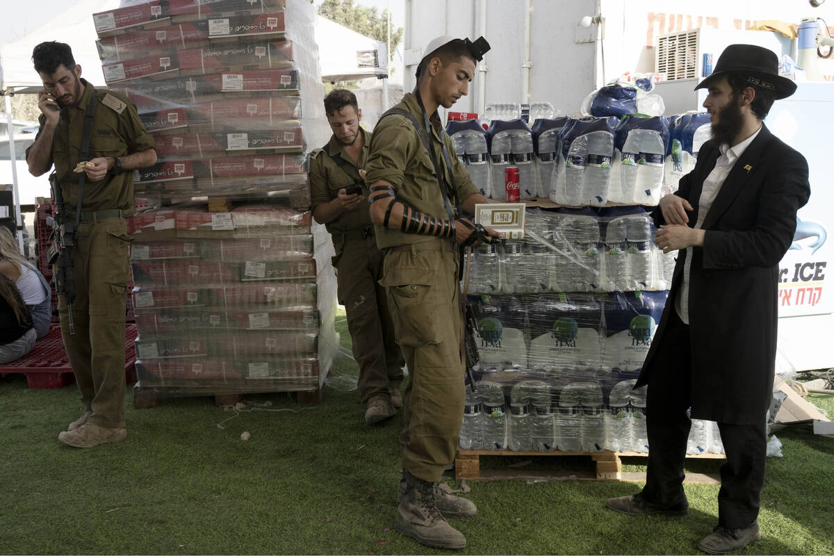 An Israeli soldier prays at a staging area near the border with the Gaza Strip, in southern Isr ...