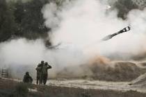 An Israeli mobile artillery unit fires a shell from southern Israel towards the Gaza Strip, in ...