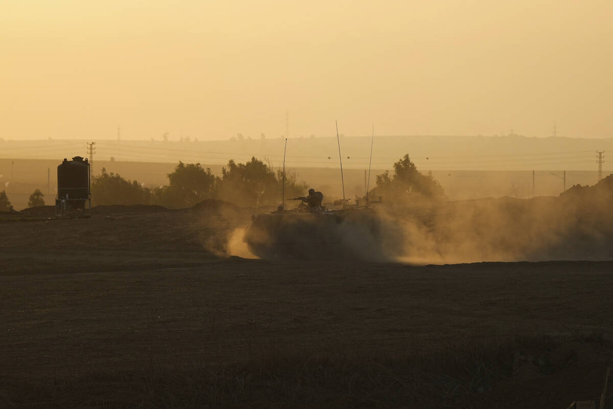 An Israeli armoured personnel carrier (APC) moves near the Gaza Strip border in southern Israel ...