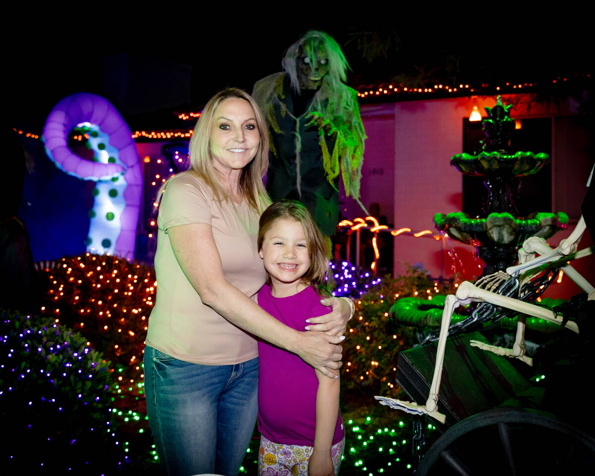 Destry Labo and daughter, Laila, stand in front of the "Halloween House," which features hundre ...