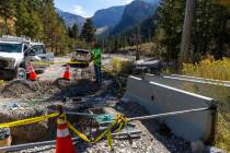 A Las Vegas Valley Water District crew reworks the lines in the Trail Canyon parking lot as rep ...