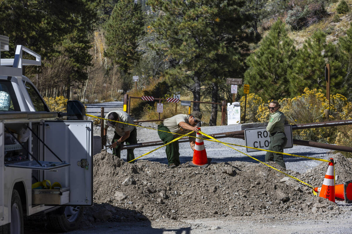 U.S. Forest Service rangers close a gate at the Trail Canyon parking lot as repairs continue at ...