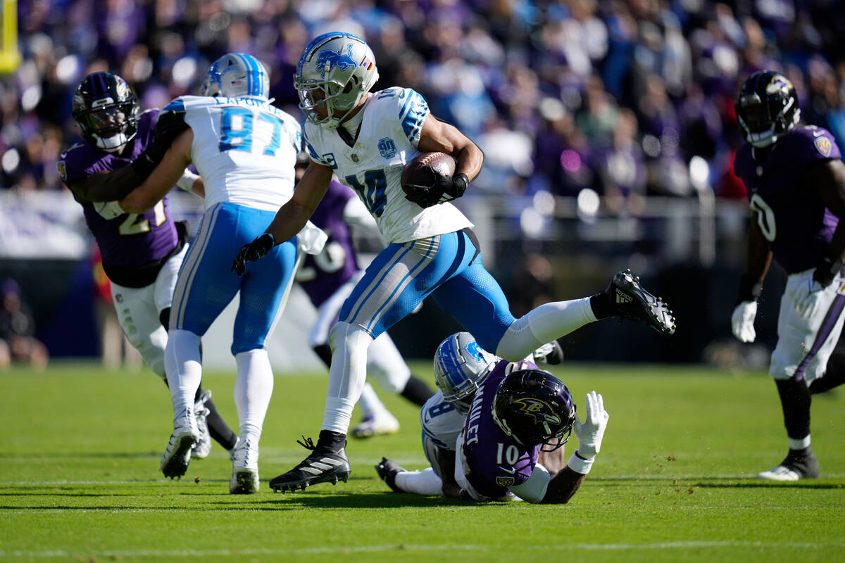Detroit Lions wide receiver Amon-Ra St. Brown (14) jumps over Baltimore Ravens cornerback Arthu ...