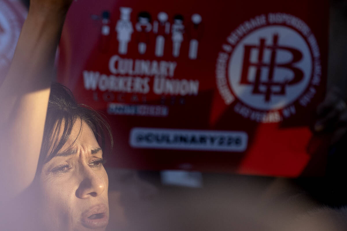 A culinary union member joins thousands in protest for a new contract during a rally along Las ...
