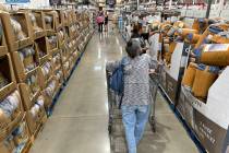 File - Shoppers look over blankets on sale in a Costco warehouse on Aug. 24, 2023, in Sheridan, ...