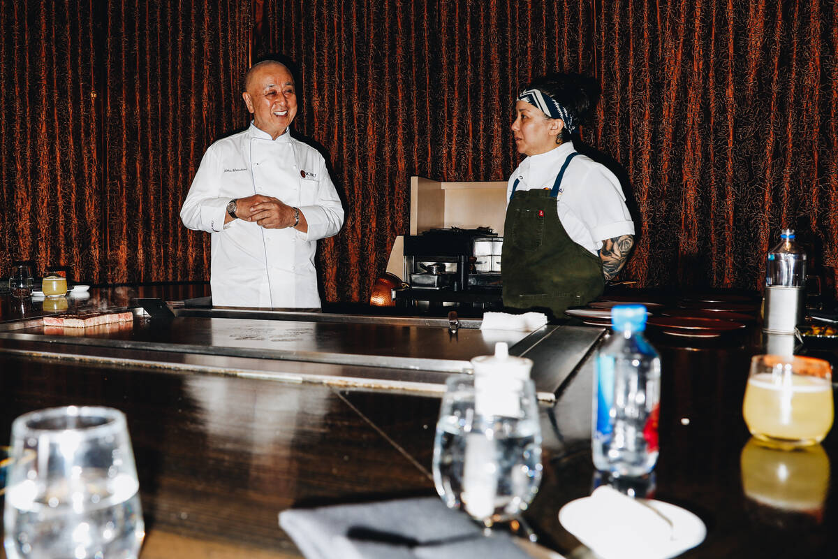 Chef Nobu Matsuhisa, with chef Jennifer Chow, demonstrates teppanyaki cooking at Nobu in Caesar ...