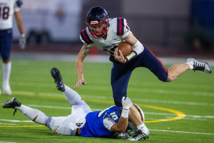 Coronado QB Aiden Krause (10) looks to break a tackle on a run over Sierra Vista LB Reese Pasio ...