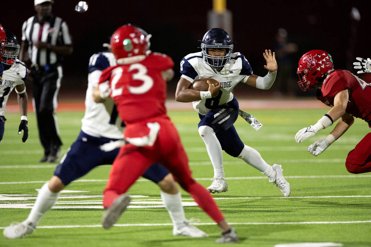 Shadow Ridge quarterback Coen Coloma (8) keeps the ball during the second half of a high school ...
