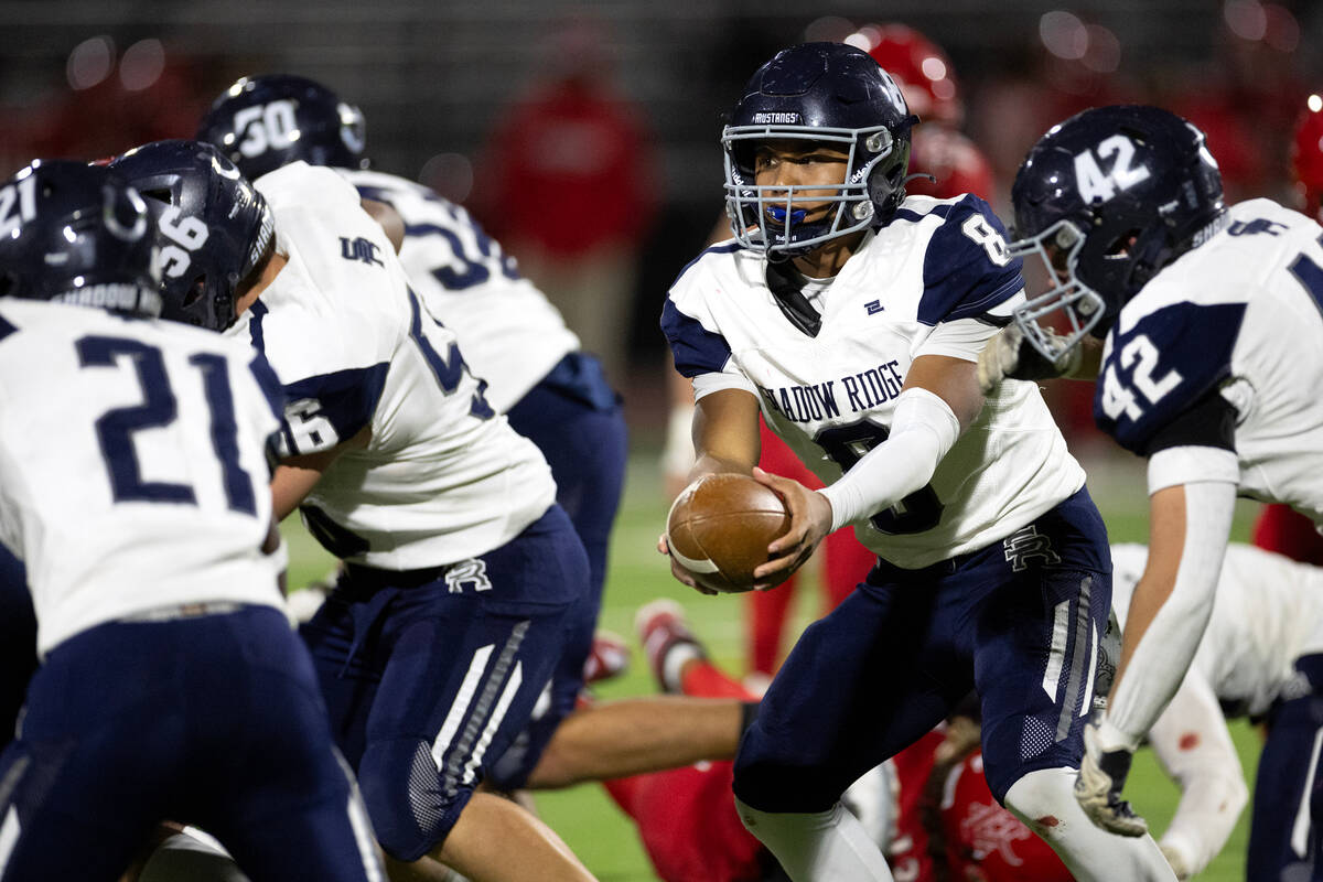 Shadow Ridge quarterback Coen Coloma (8) hands the ball off during the second half of a high sc ...