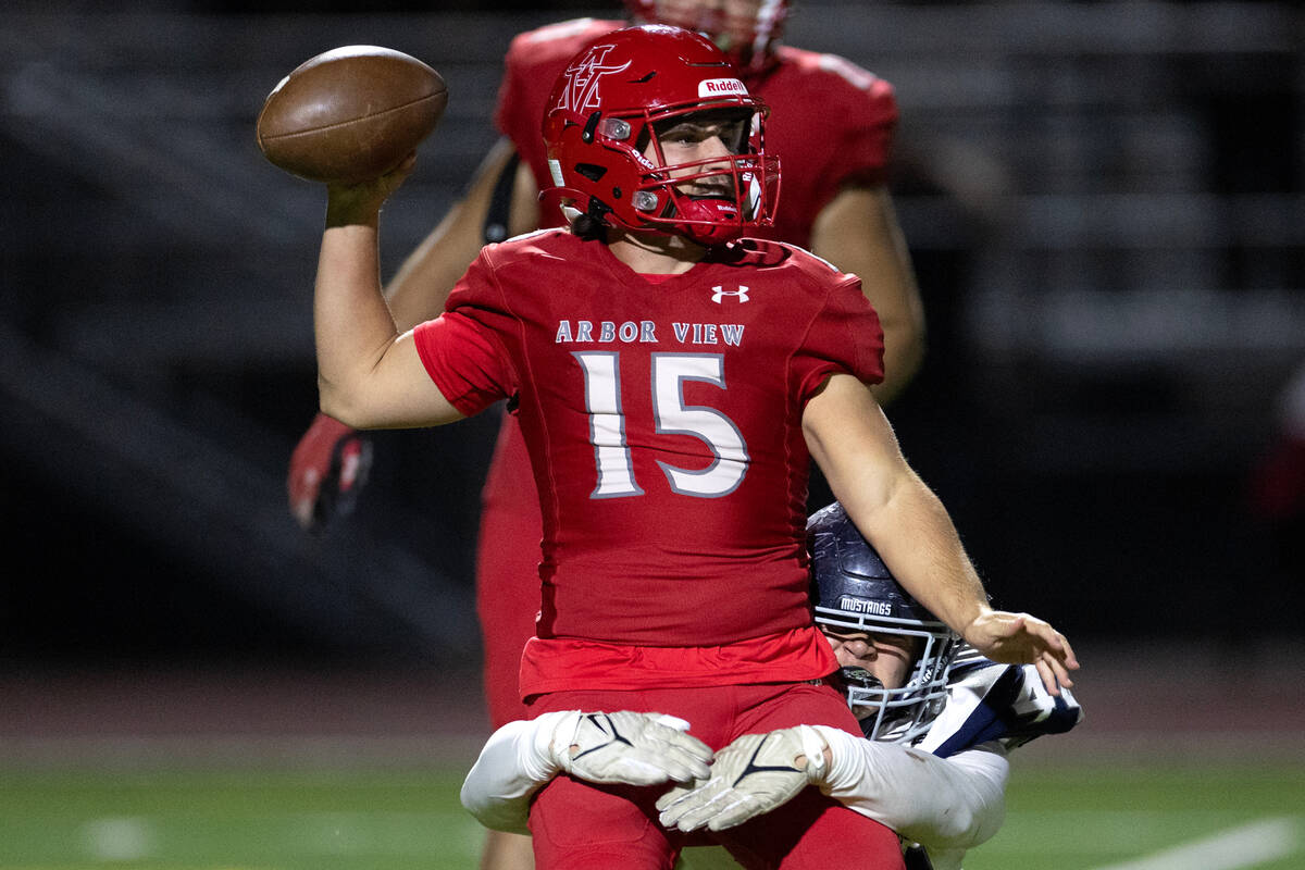 Arbor View quarterback Sean Griese (15) is tackled by Shadow Ridge defensive end Aaron Coverdel ...