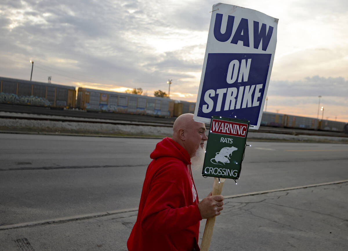 File - Dan Back, a United Auto Workers Local 12 member, pickets during the ongoing UAW strike a ...