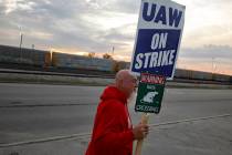 File - Dan Back, a United Auto Workers Local 12 member, pickets during the ongoing UAW strike a ...