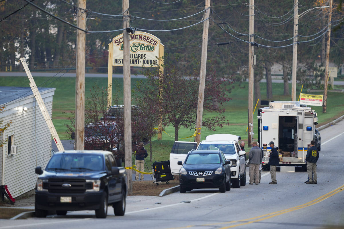 Law enforcemnt officers gather outside Schemengees Bar and Grille in the aftermath of a mass sh ...