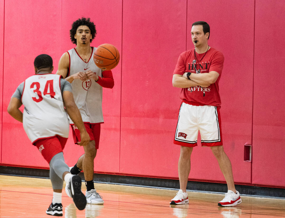 UNLV's men's basketball head coach Kevin Kruger, center, watches his players practice, on Wedne ...