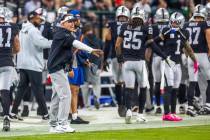 Raiders head coach Josh McDaniels talks oil the sidelines against the Green Bay Packers during ...