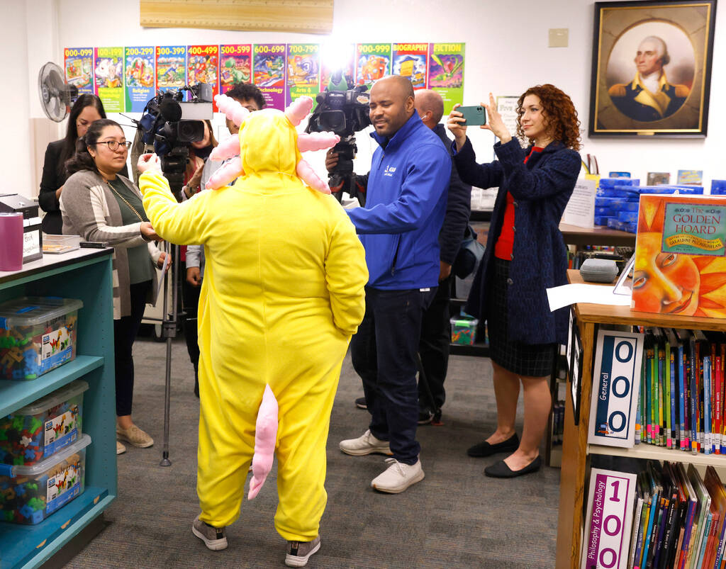 Maile Rodrigues, a second-grade teacher dressed as Axolotl, addresses the media at Piggott Acad ...