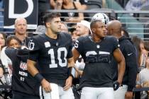 Raiders quarterback Jimmy Garoppolo (10) stands on the sideline during an NFL football game aga ...