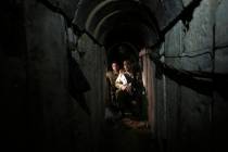 FILE - Israeli soldiers walk through a tunnel discovered near the Israel-Gaza border Sunday, Oc ...