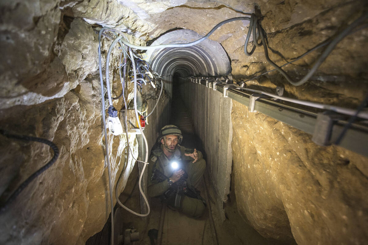 FILE - An Israeli army officer gives journalists a tour, Friday, July 25, 2014, of a tunnel all ...
