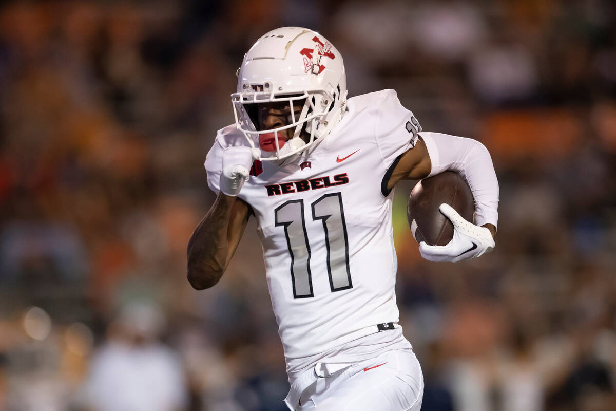 UNLV wide receiver Ricky White (11) runs for yardage during an NCAA college football game again ...