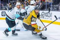 Golden Knights left wing William Carrier (28) looks back with Seattle Kraken center Jaden Schwa ...