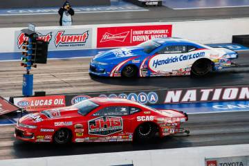 Erica Enders, bottom, takes the lead against Greg Anderson moments before winning the pro stock ...