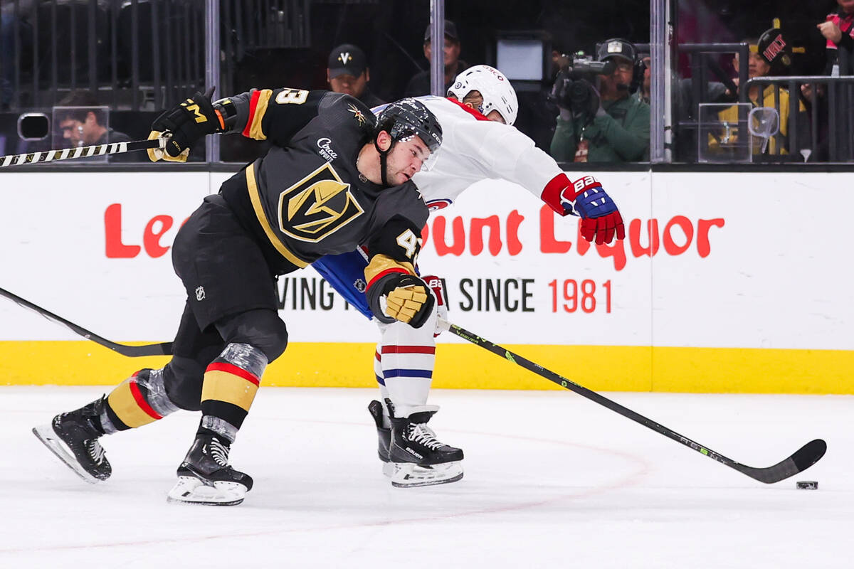 Golden Knights center Paul Cotter (43) fights past a Montreal Canadiens players to reach the pu ...