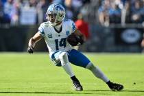 Detroit Lions wide receiver Amon-Ra St. Brown (14) runs with the ball after making a catch duri ...