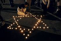 Rutgers University's students place candles with the Star of David pattern to hold solidarity a ...