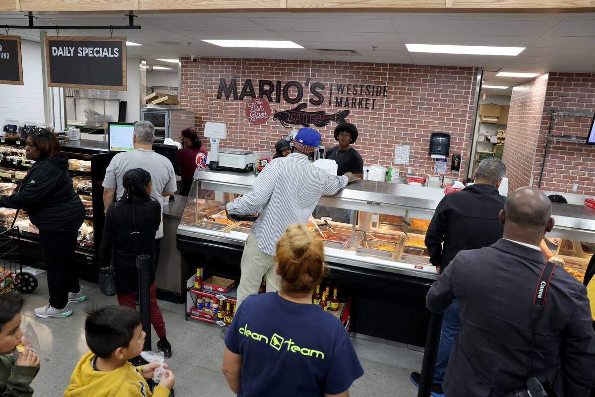 Some of the first customers make their purchases during the grand opening of the new Mario&#x20 ...