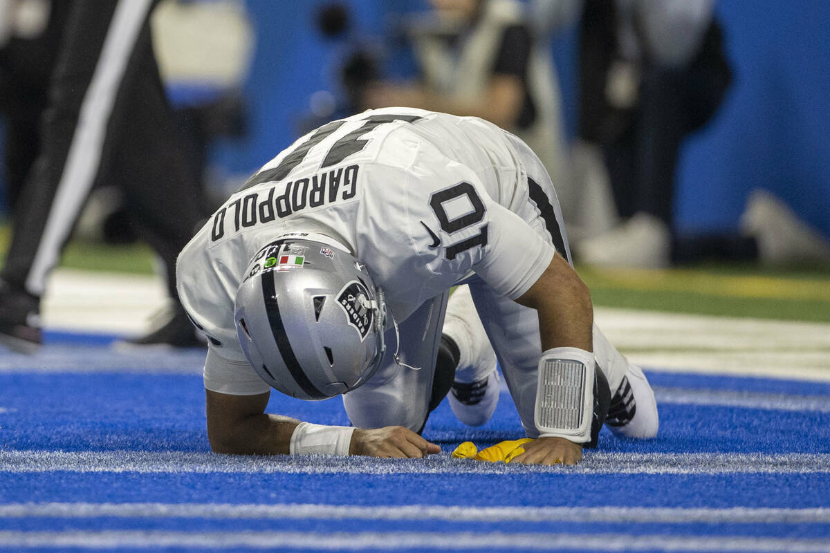 Raiders quarterback Jimmy Garoppolo (10) remains down after being hit with a flag thrown for un ...